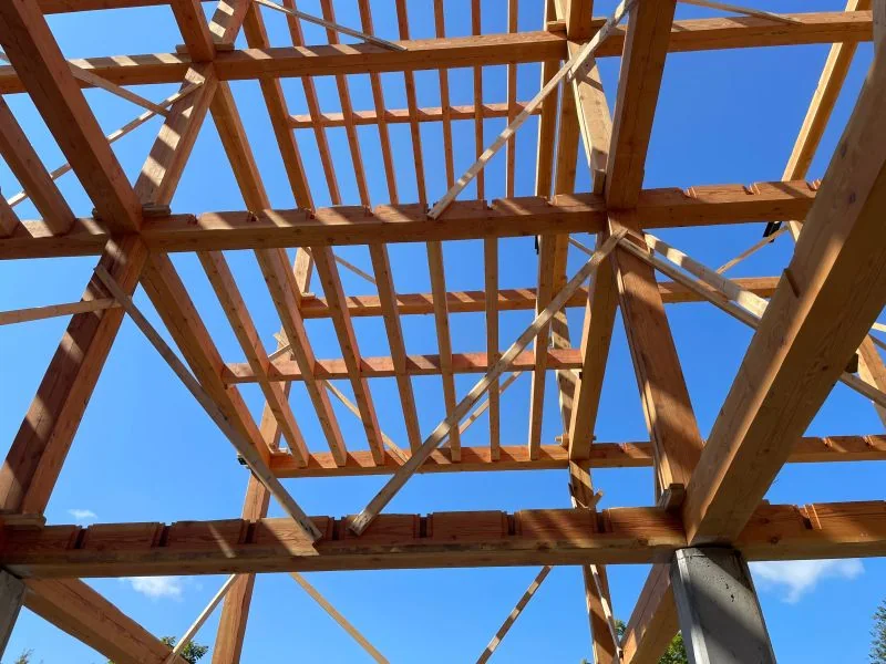 Chantier : charpente de bois sous le ciel bleu